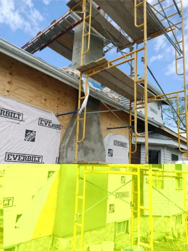 Tall chimney under construction with scaffolding against a house exterior wrapped in Everbilt sheathing.